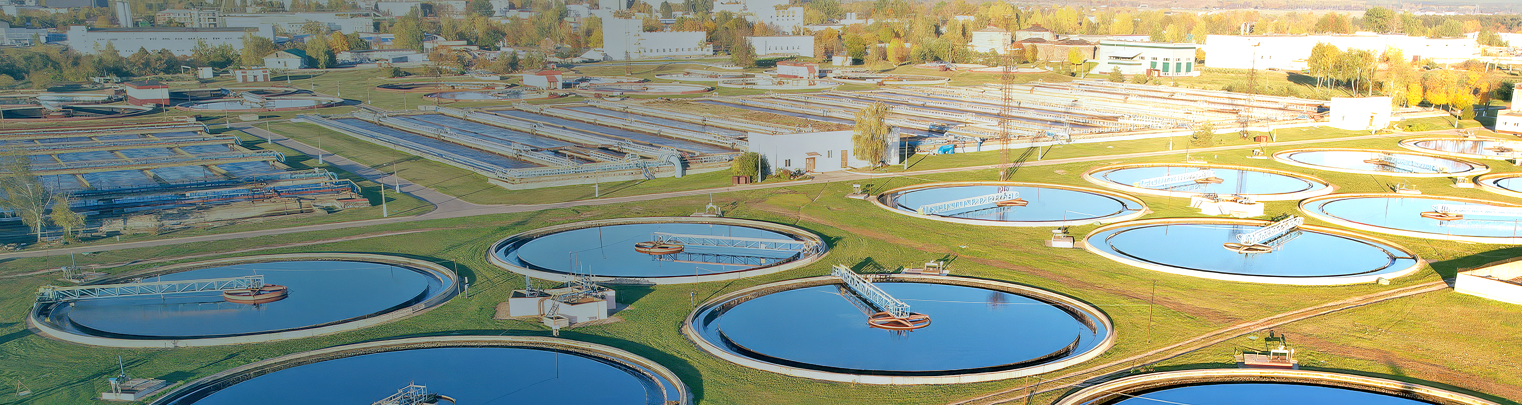 Aerial view of wastewater treatment plant with circular clarifier tanks