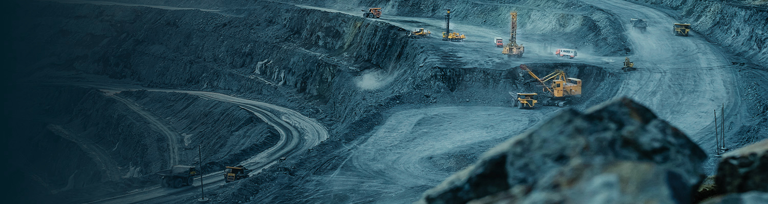 Open-pit mining operation with trucks and excavators in a large quarry