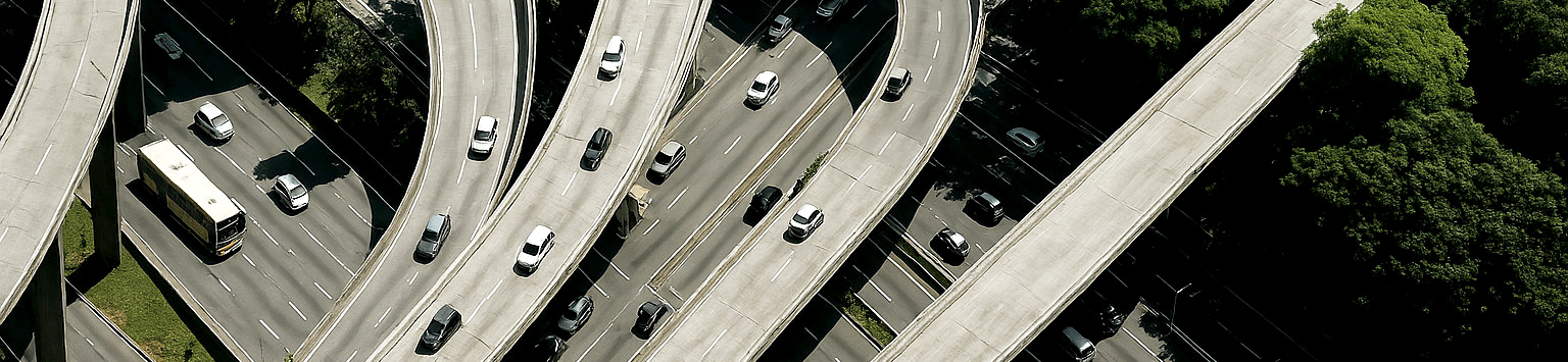 Aerial view of highway interchange, symbolizing systems supported by GE's transportation and grid tech